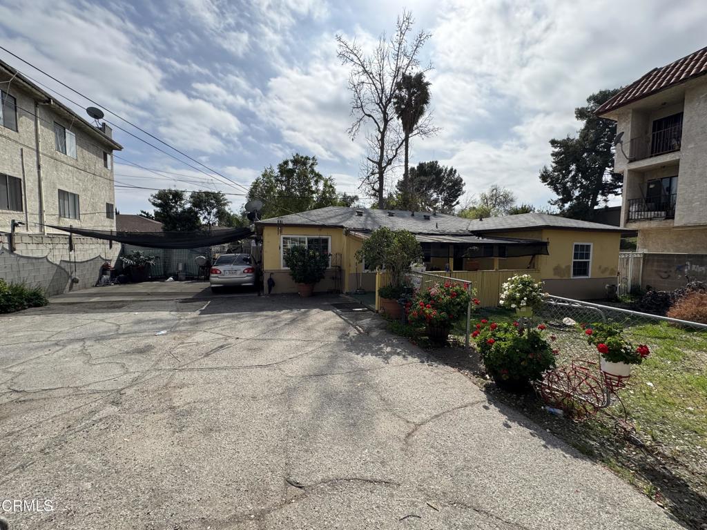 15624 Vanowen Street Van Nuys, CA 91406 - Photo 11 of 13 a view of house with yard outdoor seating and covered with trees