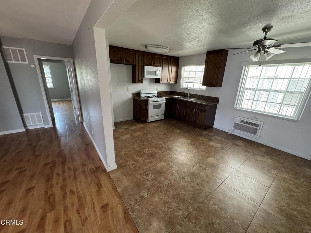 15624 Vanowen Street Van Nuys, CA 91406 - Photo 6 of 13 a kitchen with granite countertop a sink cabinets and stainless steel appliances
