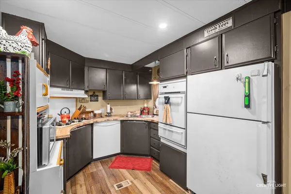 a kitchen with stainless steel appliances a refrigerator sink and microwave