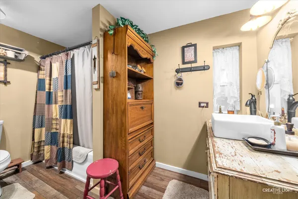 a bathroom with a granite countertop tub sink and a mirror