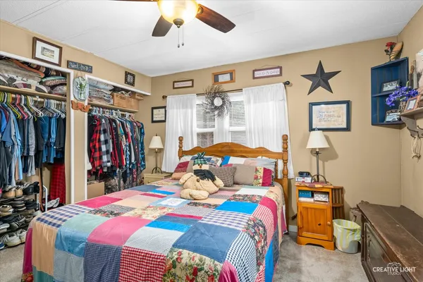 a bedroom with a bed a walk in closet and a large closet