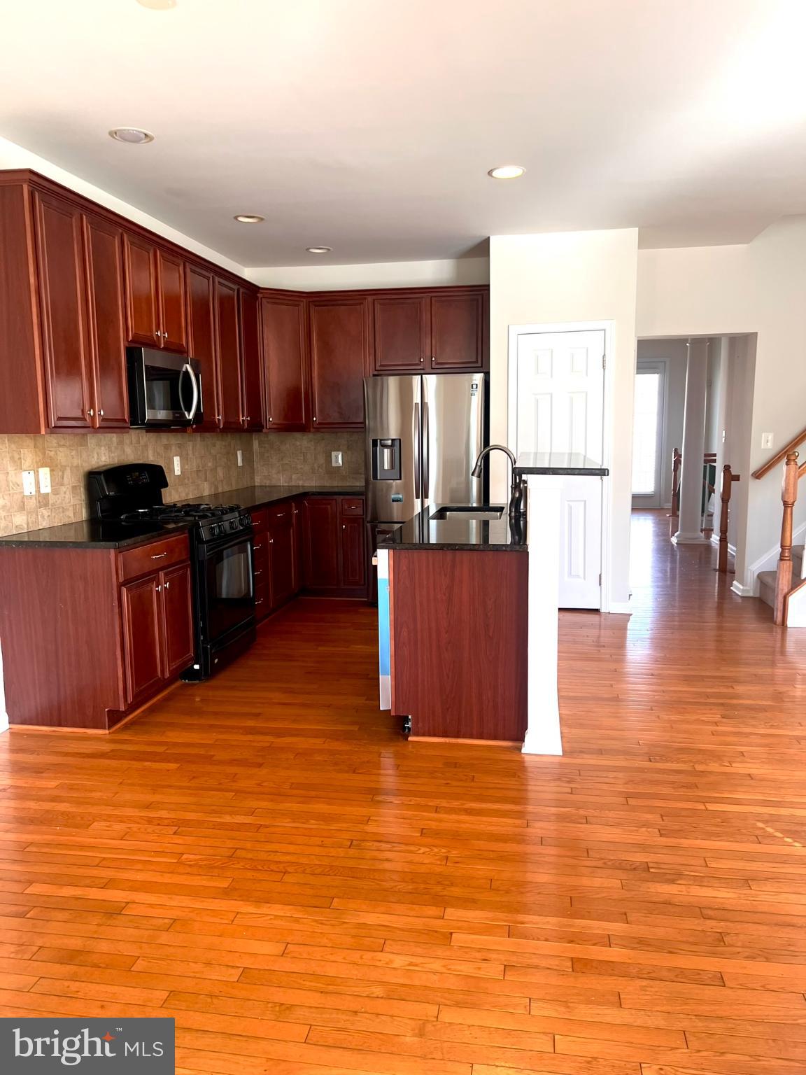 25205 Larks Terrace Chantilly, VA 20152 - Photo 2 of 28 Modern kitchen with rich wood accents.