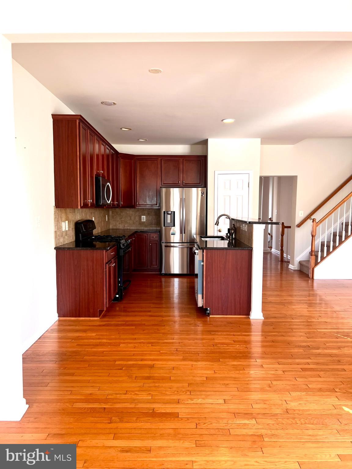 25205 Larks Terrace Chantilly, VA 20152 - Photo 3 of 28 Modern kitchen with warm wood accents.
