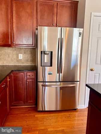 a kitchen with stainless steel appliances granite countertop a refrigerator and a cabinets