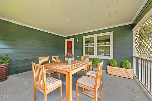 a view of a patio with a table and chairs