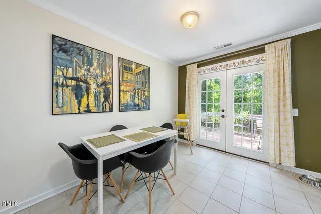 a view of a dining room with furniture and a large window