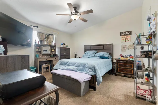 a bedroom with a bed furniture and a flat tv screen