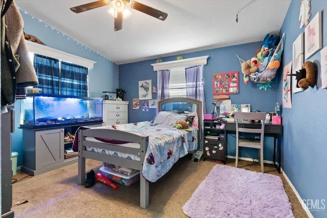 a bedroom with bed and a window