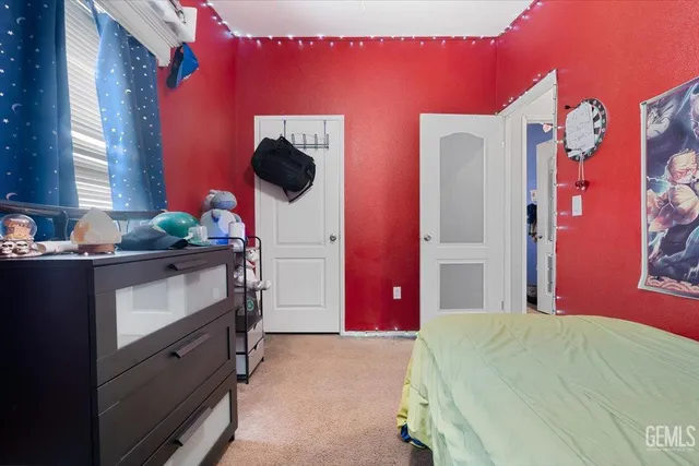 a bed room with a bed and a television