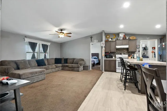 a living room with furniture and kitchen view