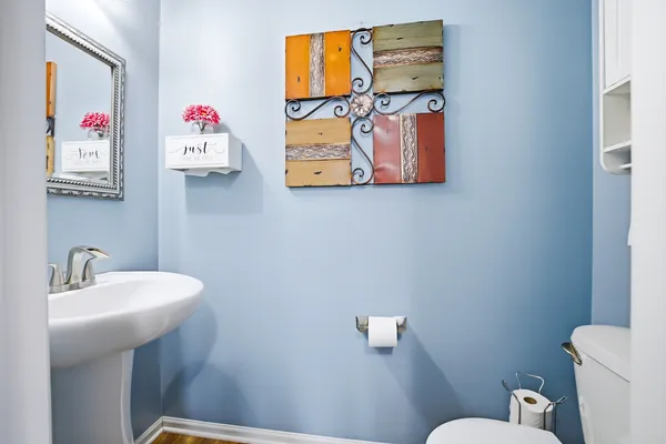 a bathroom with a sink mirror and toilet