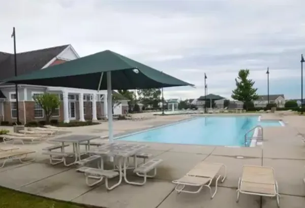 a patio with a table and chairs under an umbrella