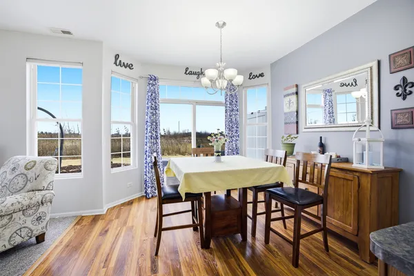 a view of a dining room with furniture window and wooden floor