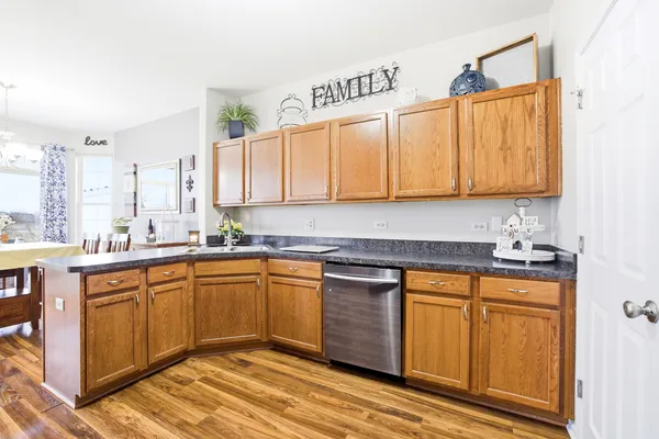 a kitchen with stainless steel appliances granite countertop a sink and cabinets