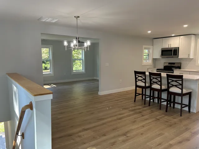a view of a dining room with furniture window and wooden floor