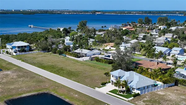 an aerial view of a house with a garden and lake view