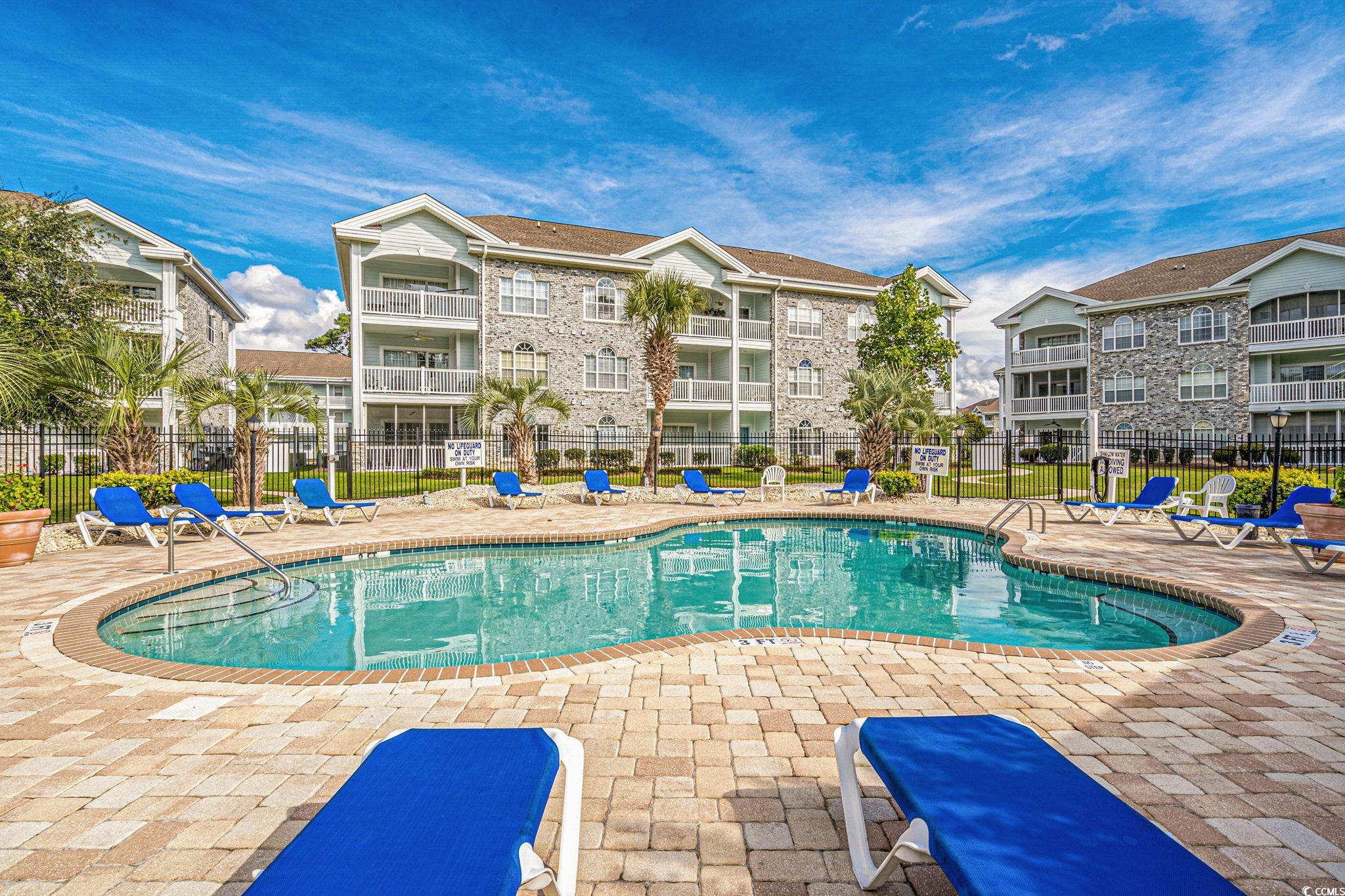 4815 Orchid Way, Unit 302 Myrtle Beach, SC 29577 - Photo 24 of 26 Community pool with a patio