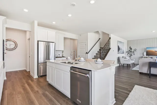 a kitchen with stainless steel appliances kitchen island a sink stove and refrigerator