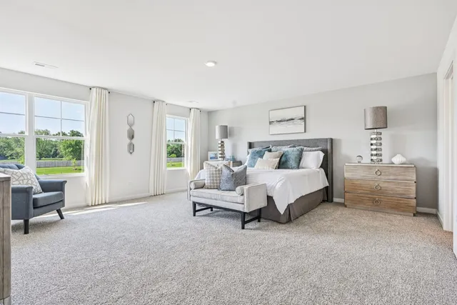 a spacious bedroom with a bed and a couch