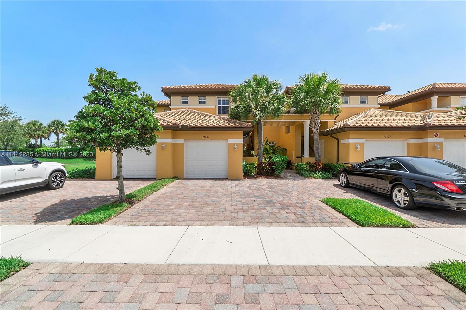Heron Bay Parkland, FL 33076 - Photo 2 of 60 a view of a car parked on the side of a road