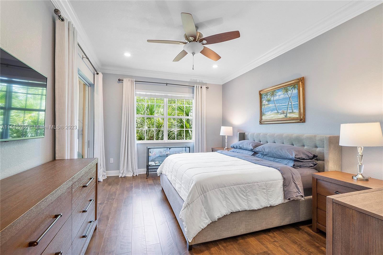 Heron Bay Parkland, FL 33076 - Photo 23 of 60 a bedroom with a large bed and a window