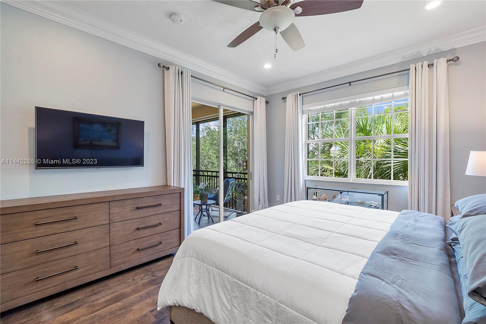 Heron Bay Parkland, FL 33076 - Photo 24 of 60 a bedroom with a large bed and a flat screen tv