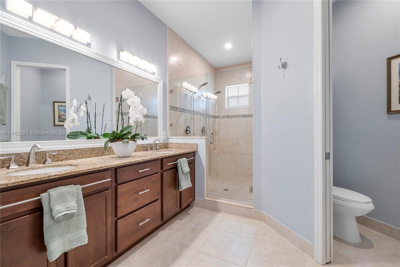 Heron Bay Parkland, FL 33076 - Photo 27 of 60 a bathroom with a double vanity sink toilet and a mirror