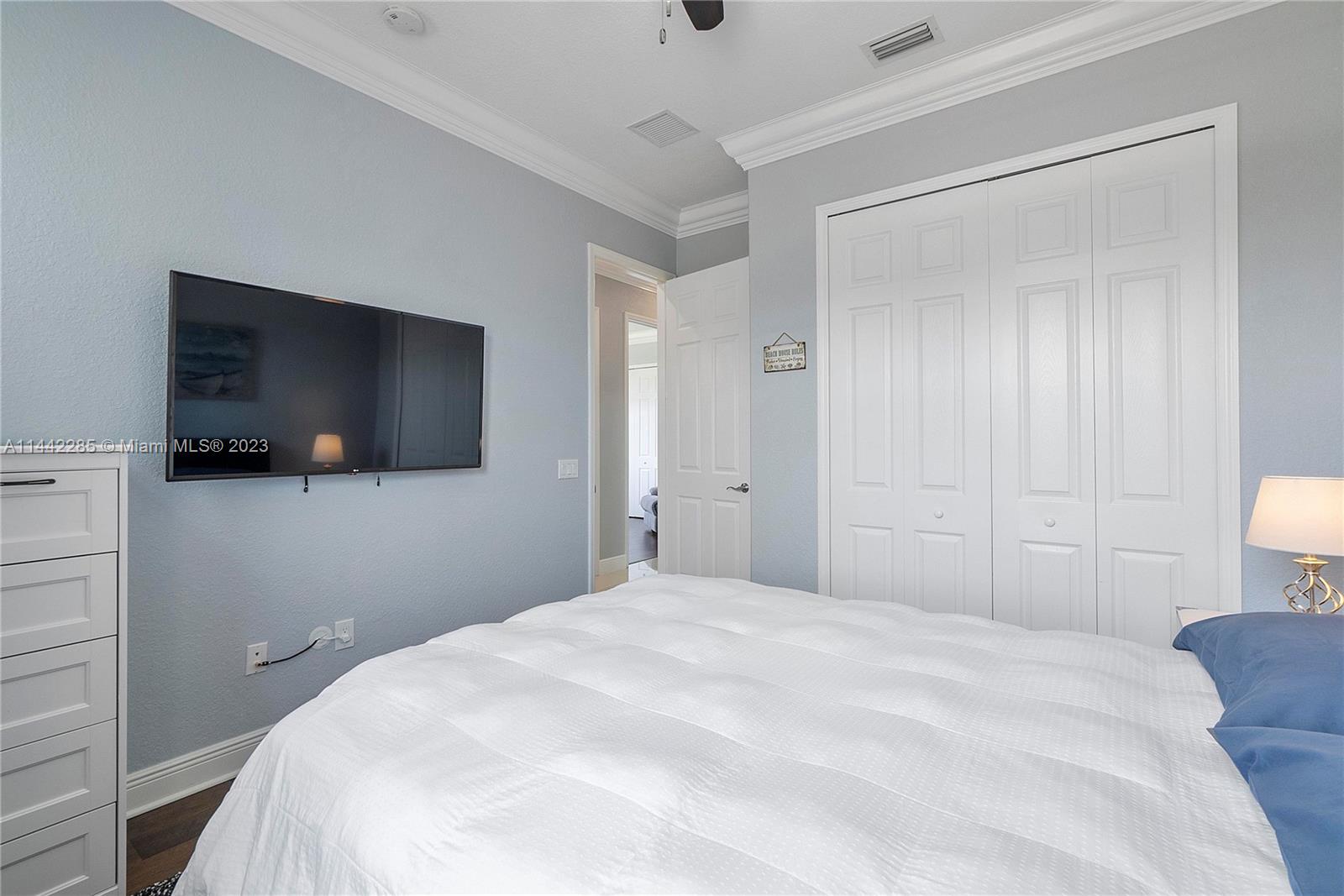 Heron Bay Parkland, FL 33076 - Photo 33 of 60 a bedroom with a flat screen tv and a bed