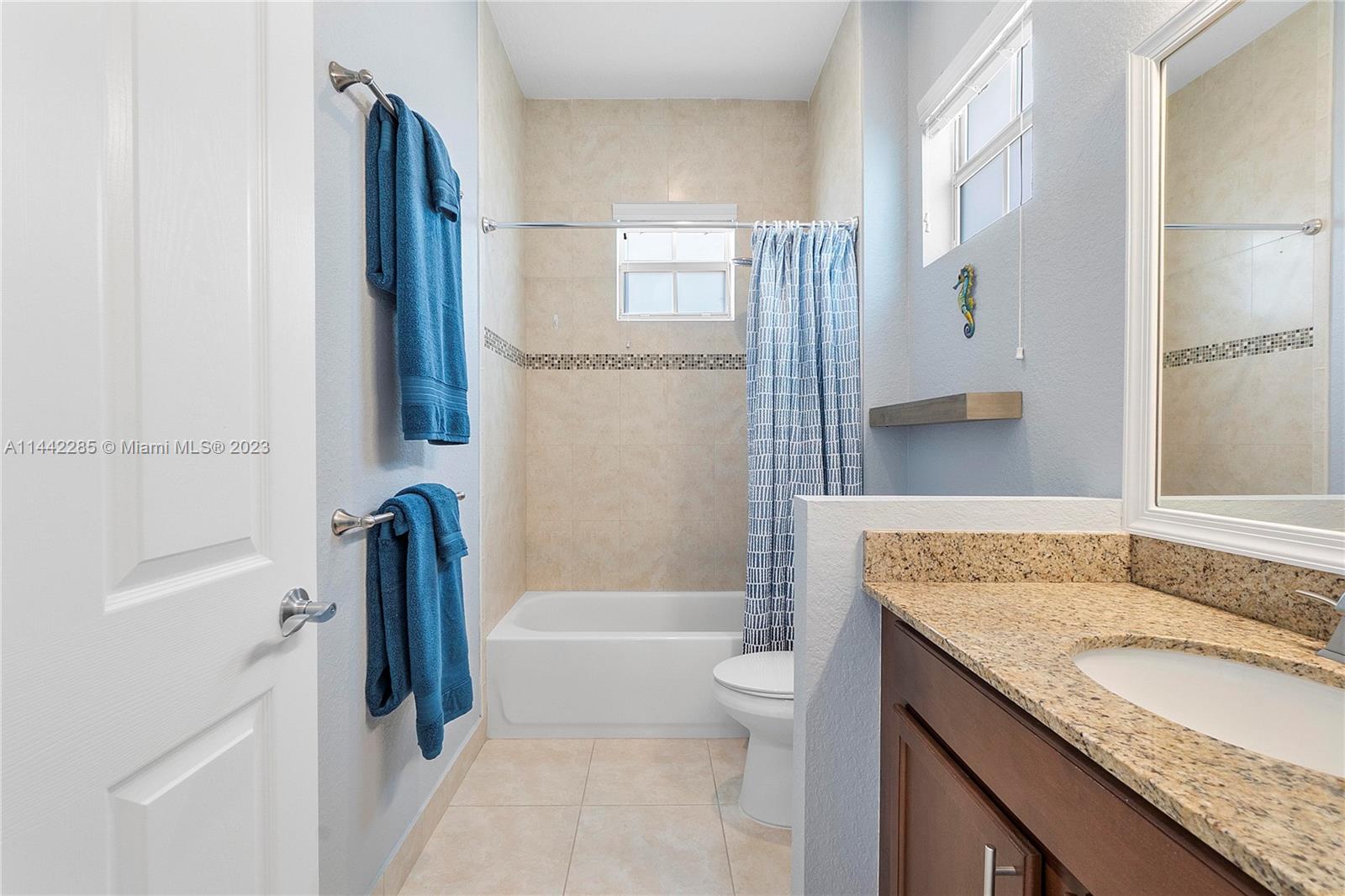 Heron Bay Parkland, FL 33076 - Photo 37 of 60 a bathroom with a granite countertop sink toilet and shower