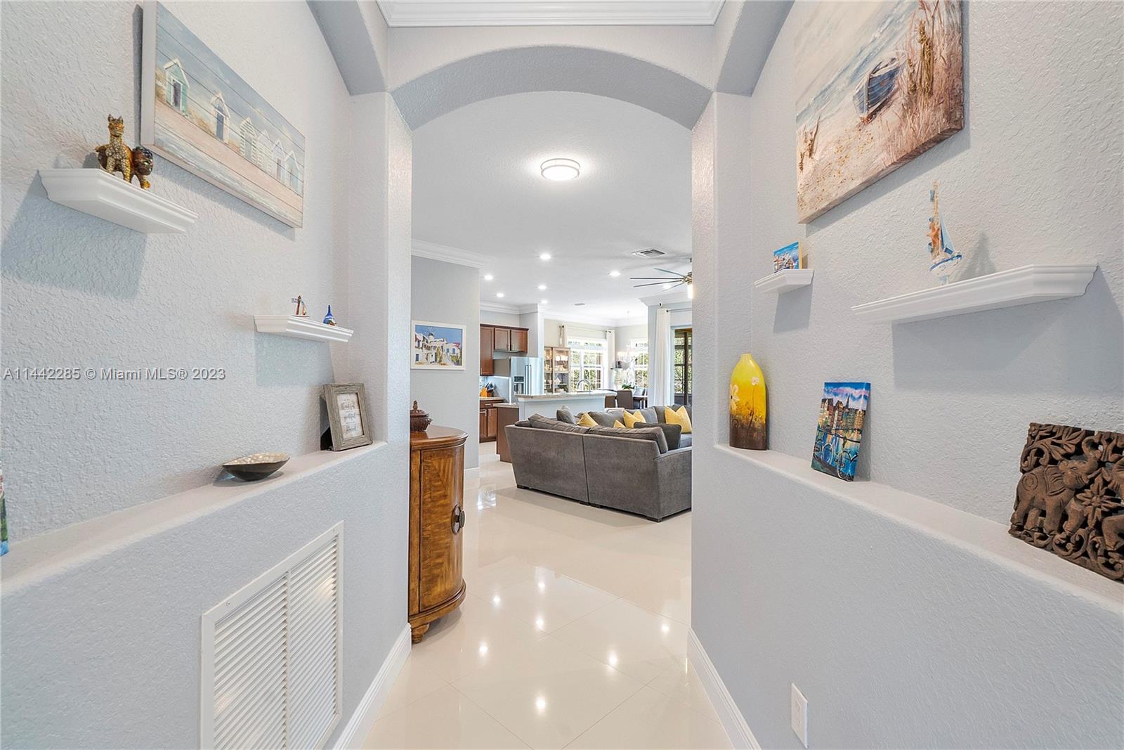 Heron Bay Parkland, FL 33076 - Photo 39 of 60 a view of a kitchen with kitchen island a sink a counter space and stainless steel appliances