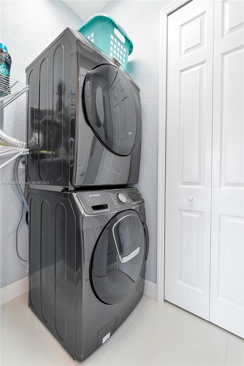 Heron Bay Parkland, FL 33076 - Photo 42 of 60 a utility room with dryer and washer