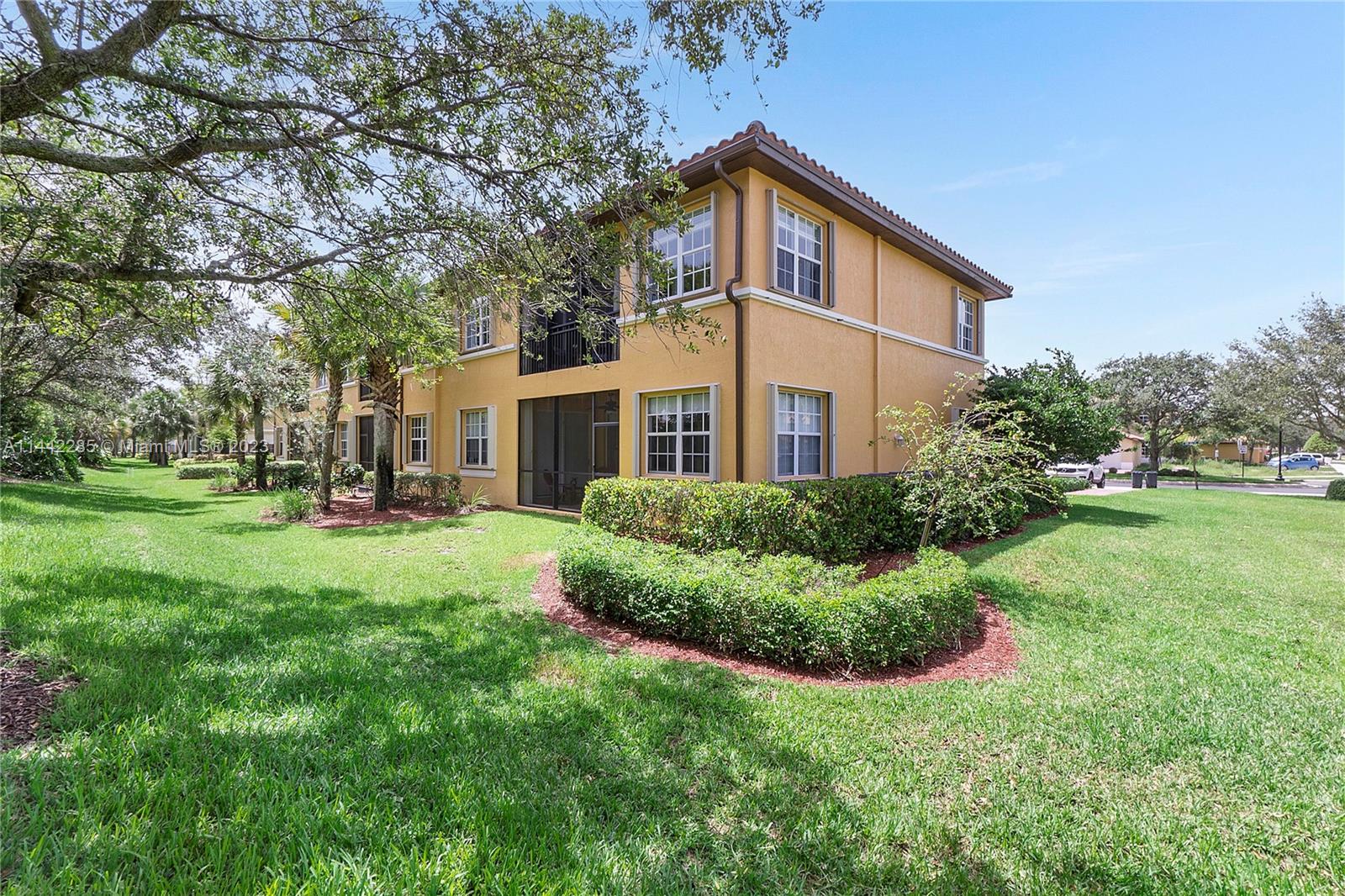 Heron Bay Parkland, FL 33076 - Photo 5 of 60 a front view of a house with a yard