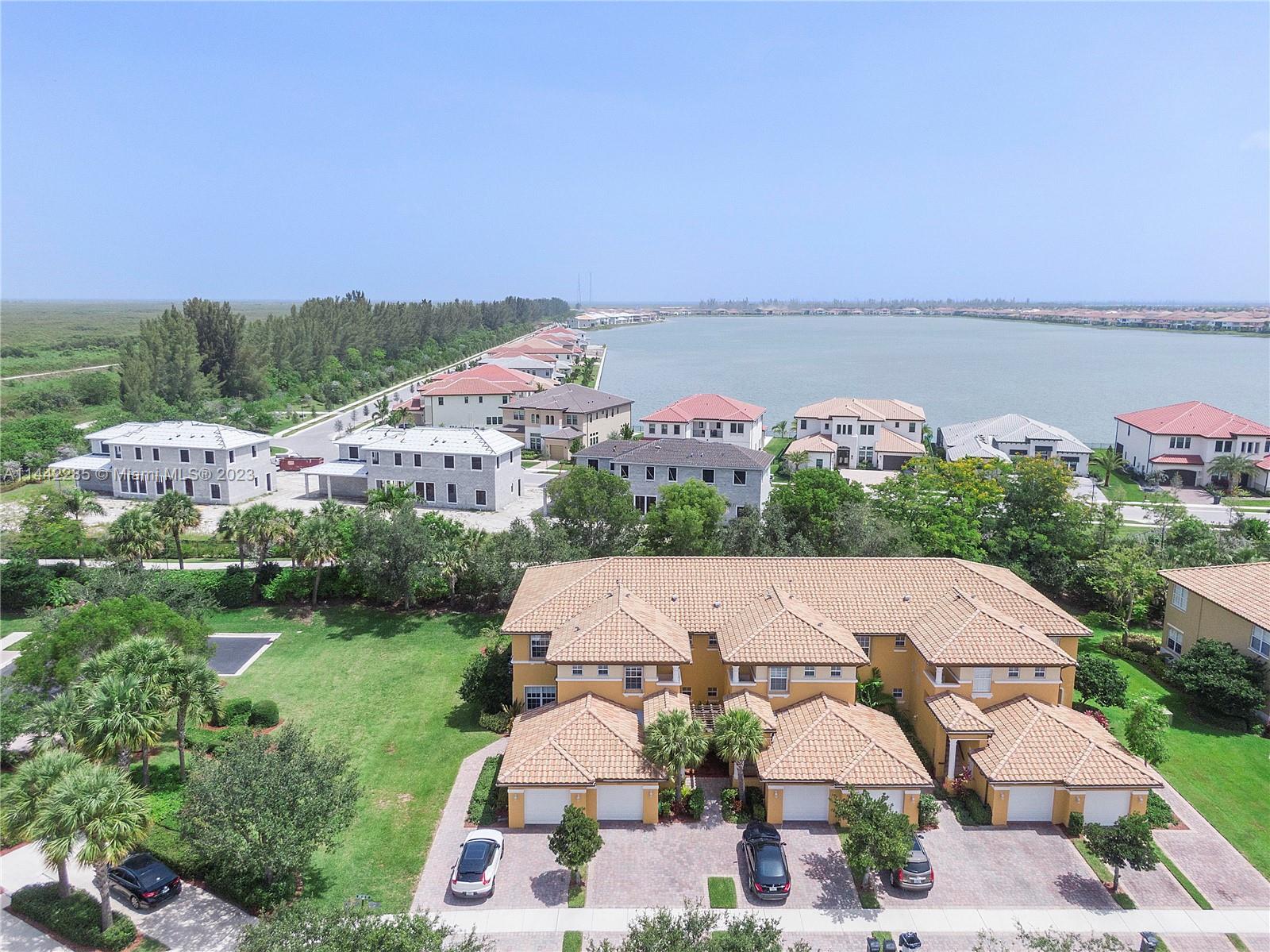 Heron Bay Parkland, FL 33076 - Photo 54 of 60 an aerial view of a house with a garden and lake view
