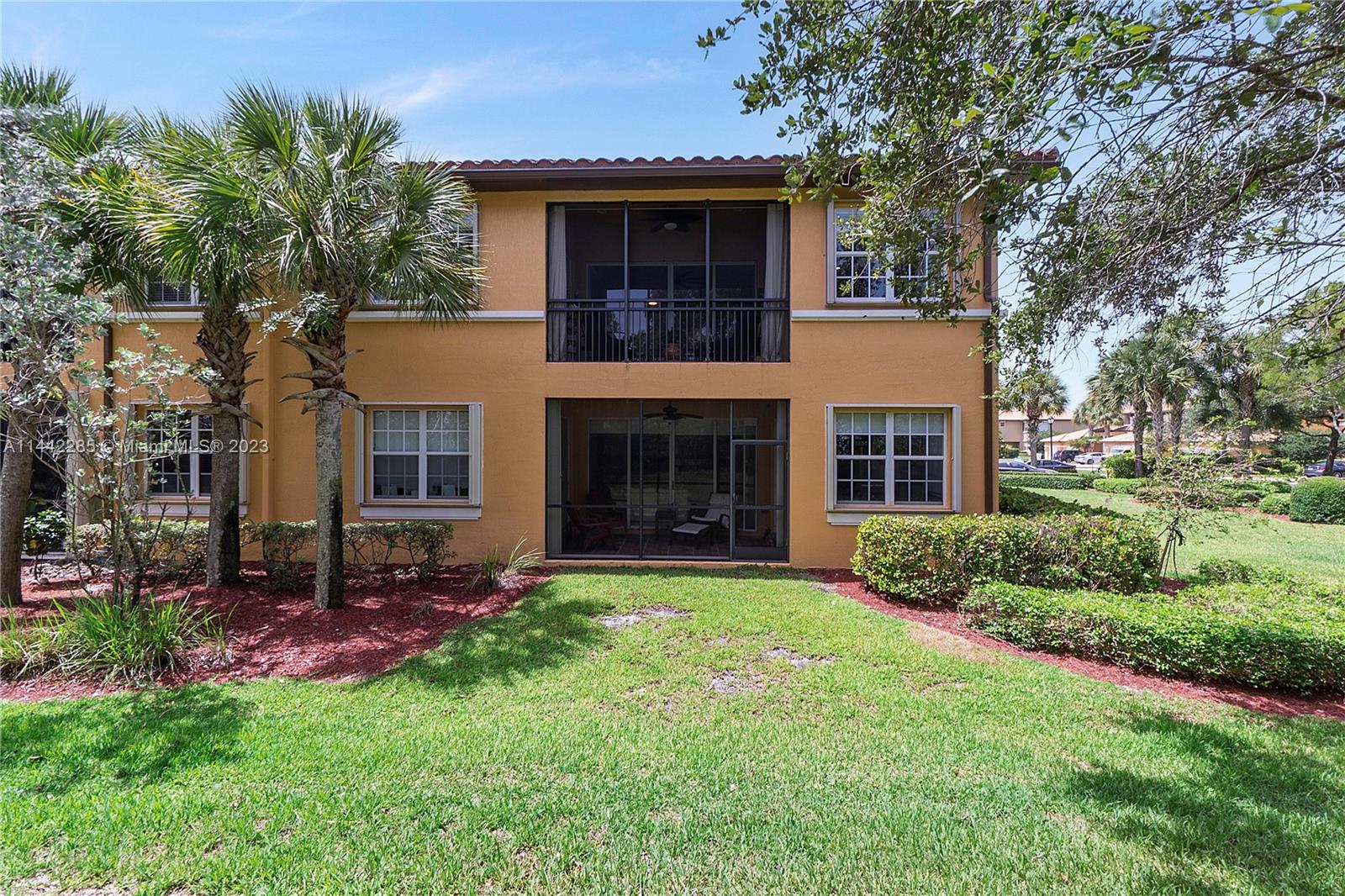 Heron Bay Parkland, FL 33076 - Photo 6 of 60 a front view of a house with a garden and yard