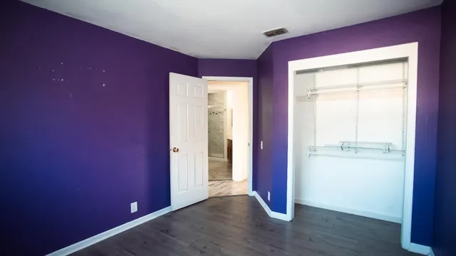 a bathroom with a granite countertop sink a mirror and a bathtub