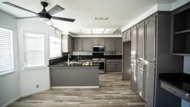 a kitchen with a stove and a refrigerator