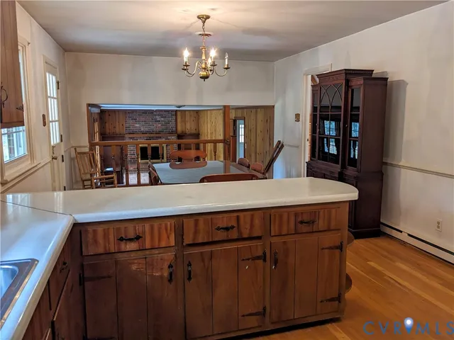 a view of a dining room with furniture and a chandelier