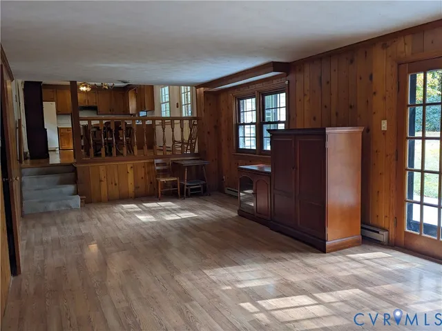 an empty room with a empty space and windows