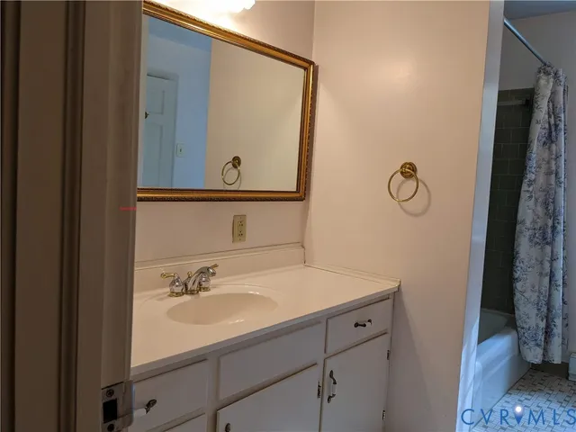 an empty room with wooden floor and cabinet