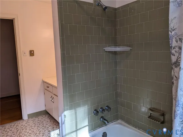 a view of a small space with wooden floor and a window