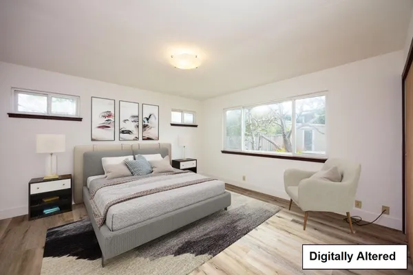 a bedroom with a large bed and a window
