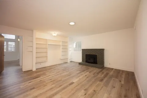 wooden floor in an empty room with a fireplace