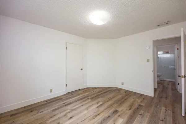 a view of room with wooden floor