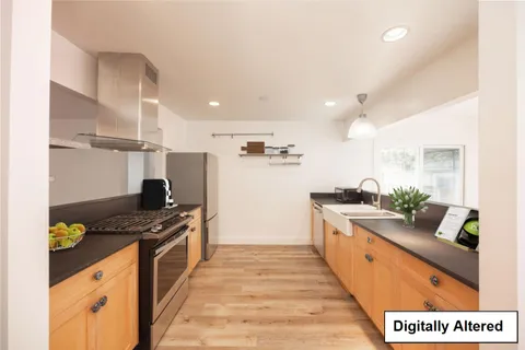 a kitchen with stainless steel appliances granite countertop a stove and a refrigerator