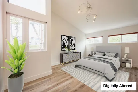 a bedroom with a bed a chandelier and couch