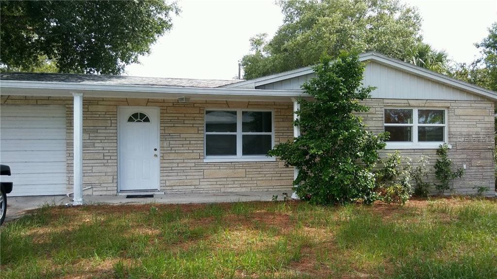 6250 Indiana Avenue New Port Richey, FL 34653 - Photo 1 of 1 a front view of house with yard