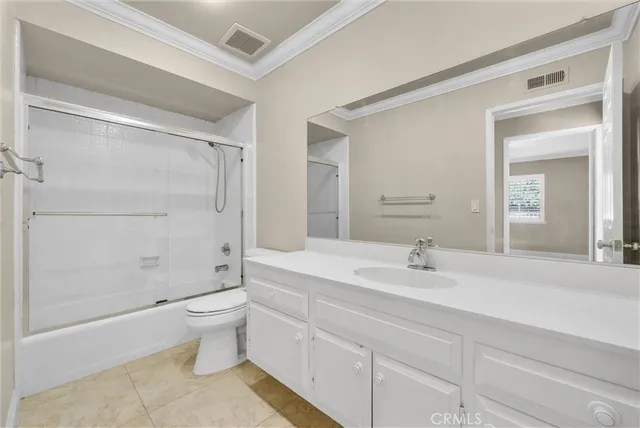 a bathroom with a double vanity sink toilet and shower
