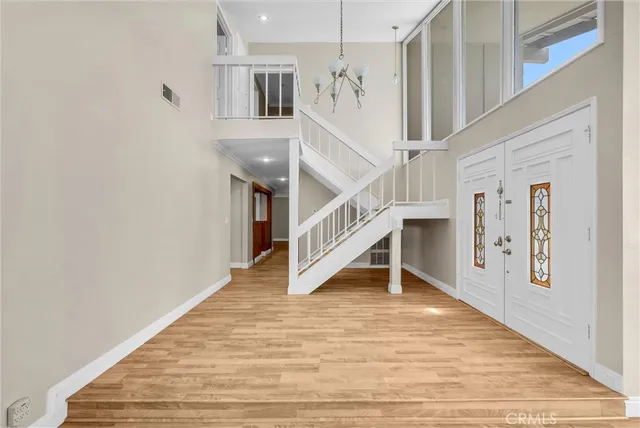 a view of entryway and hall with wooden floor