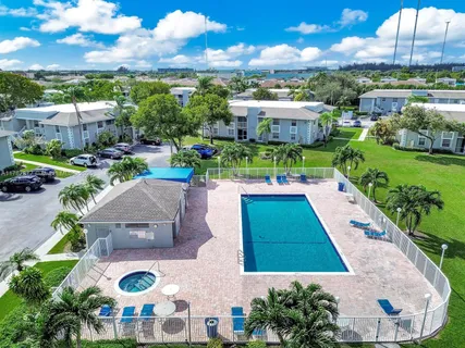 an aerial view of a house with yard swimming pool and outdoor seating