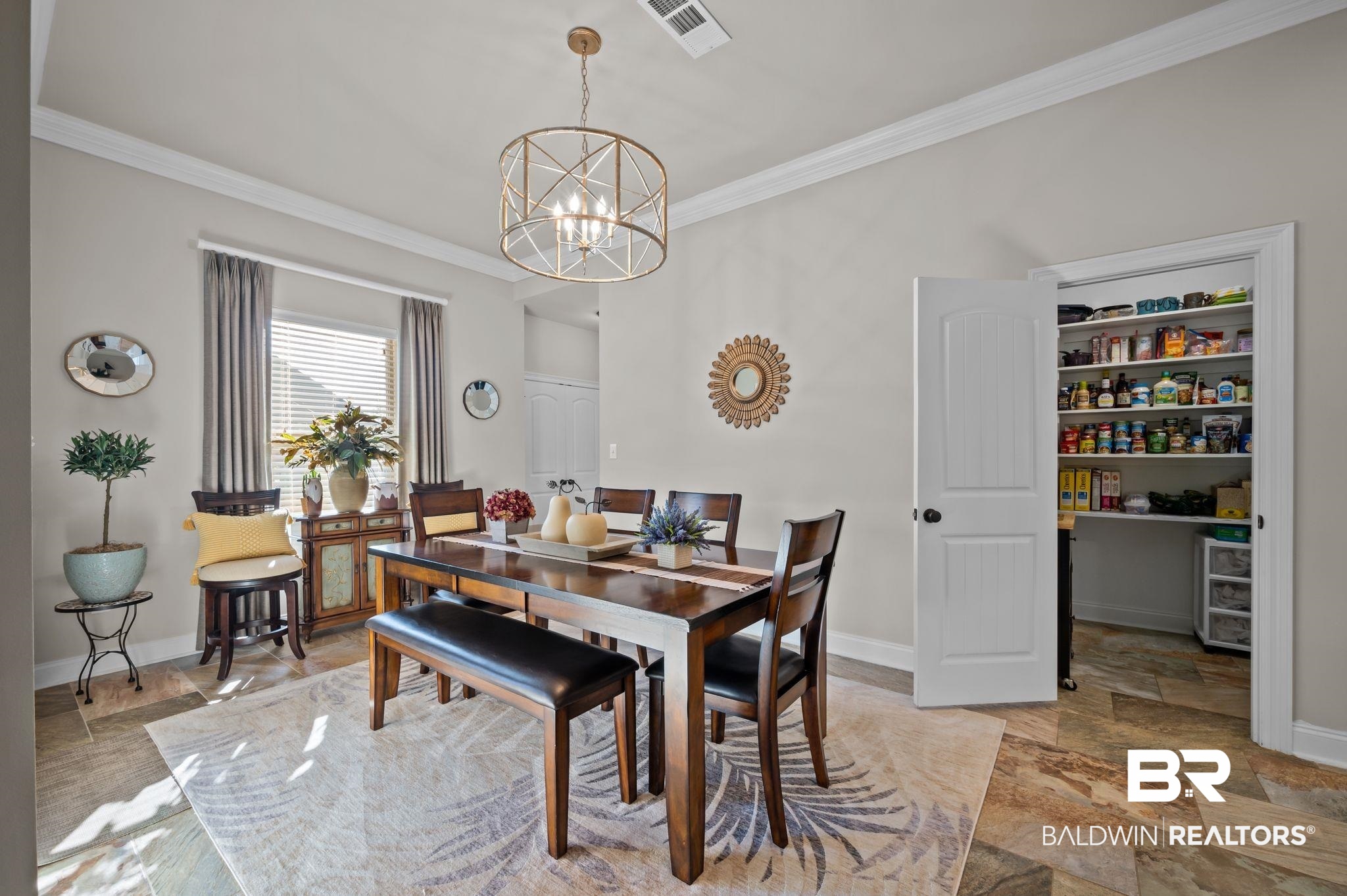 33842 Rutland Lane Spanish Fort, AL 36527 - Photo 14 of 42 BFast room with a notable chandelier, visible vents, baseboards, and ornamental molding